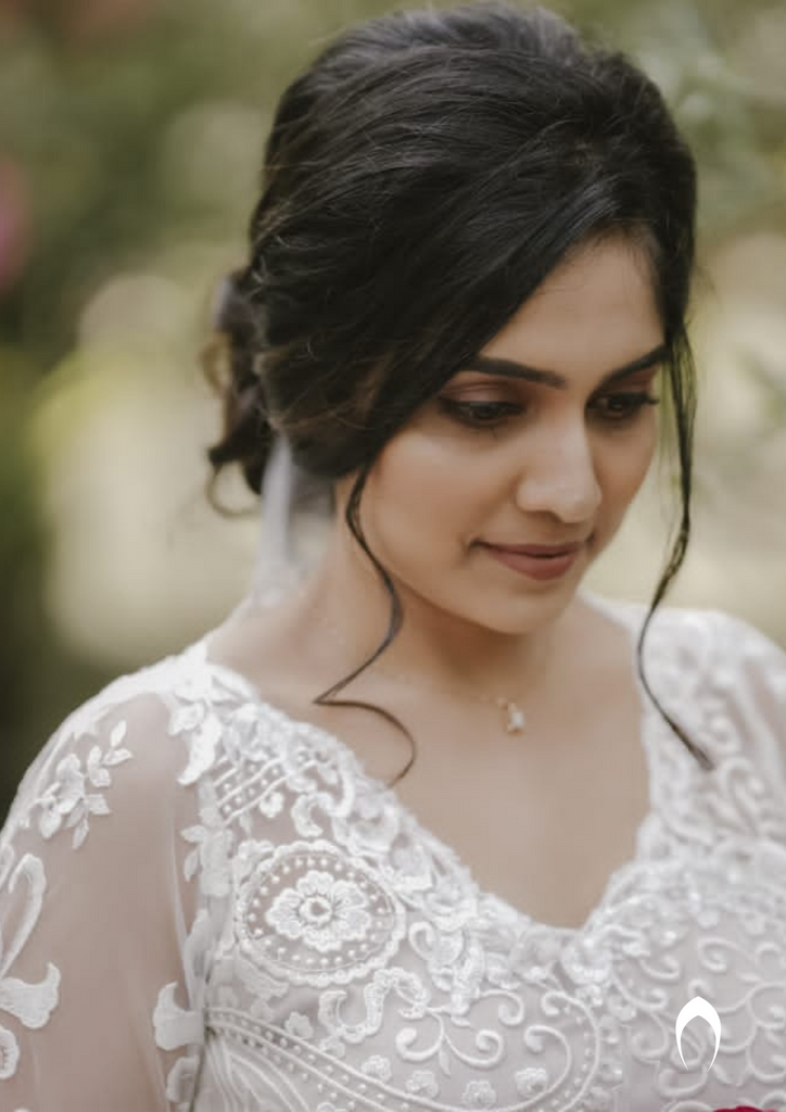Signature christian bridal trailing champagne gown carried by bride Anuja
