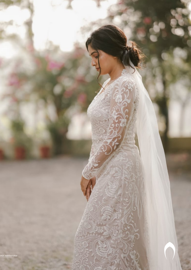 Signature christian bridal trailing champagne gown carried by bride Anuja