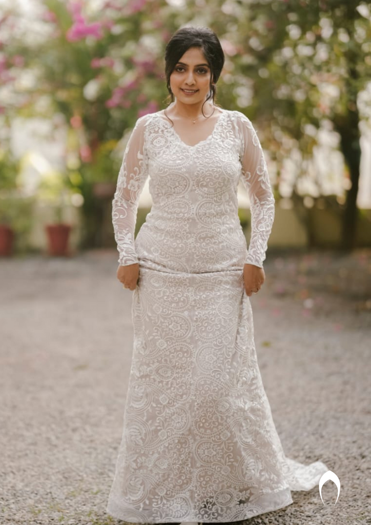 Signature christian bridal trailing champagne gown carried by bride Anuja