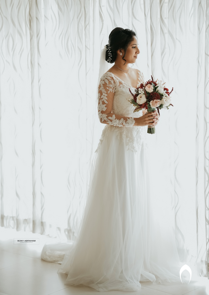 Signature christian bridal A-line gown with an illusion V neck