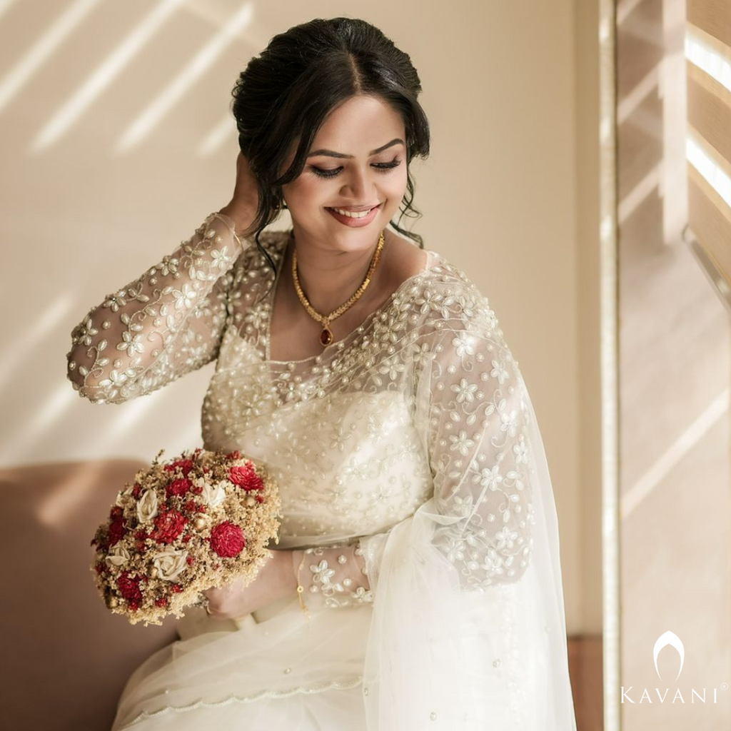 Our beautiful bride in her white bridal saree and elegant and stunning hand embroidery