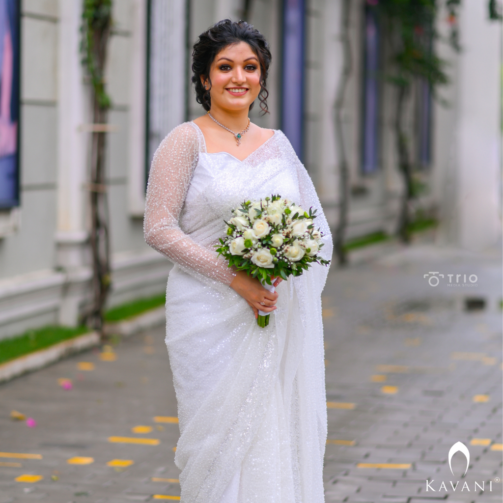 Our bride in her white bridal saree with sequence work with heavy hand embroidey