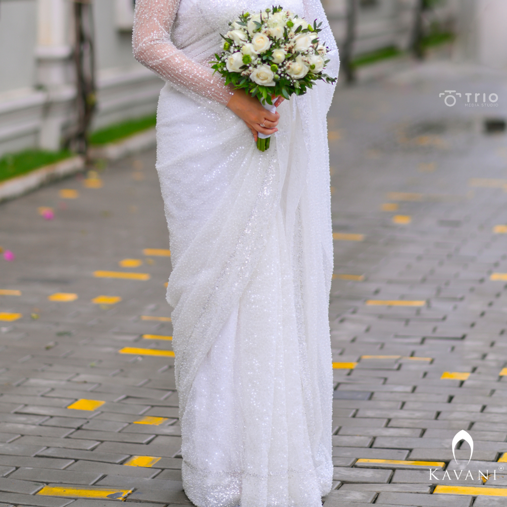 Our bride in her white bridal saree with sequence work with heavy hand embroidey