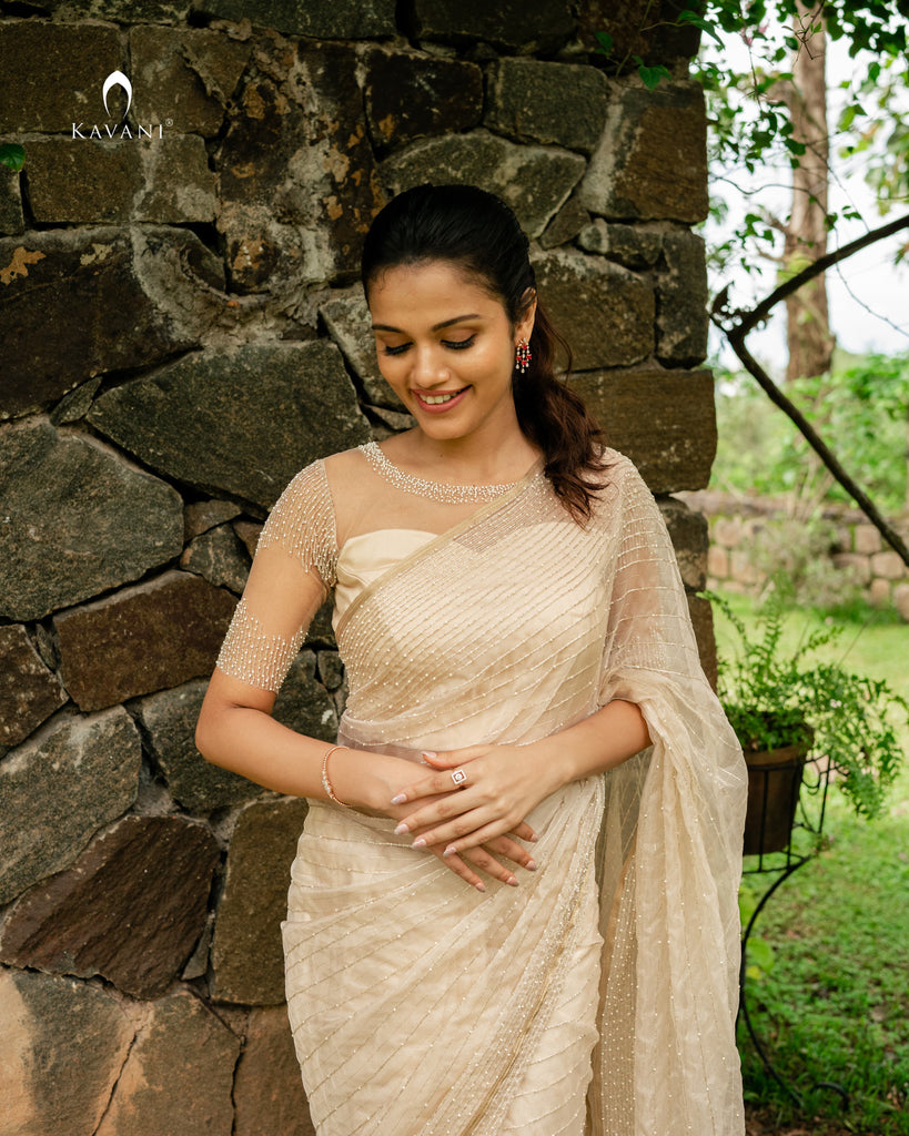 Our signature bridal saree in a light gold shade with beautiful lines of hand embroidery