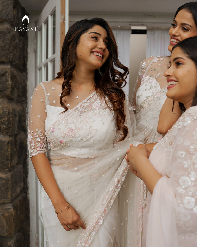 Our signature designer bridal off white saree with hand embroidery with a little pink and rosgold work