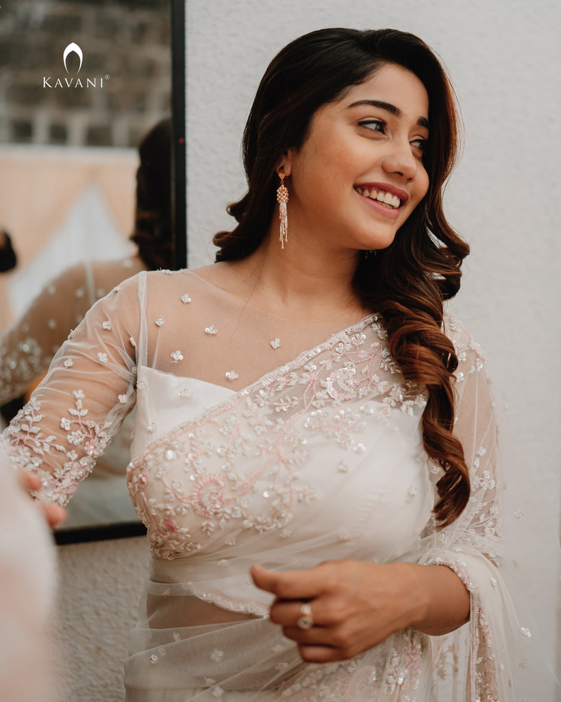 Our signature designer bridal off white saree with hand embroidery with a little pink and rosgold work