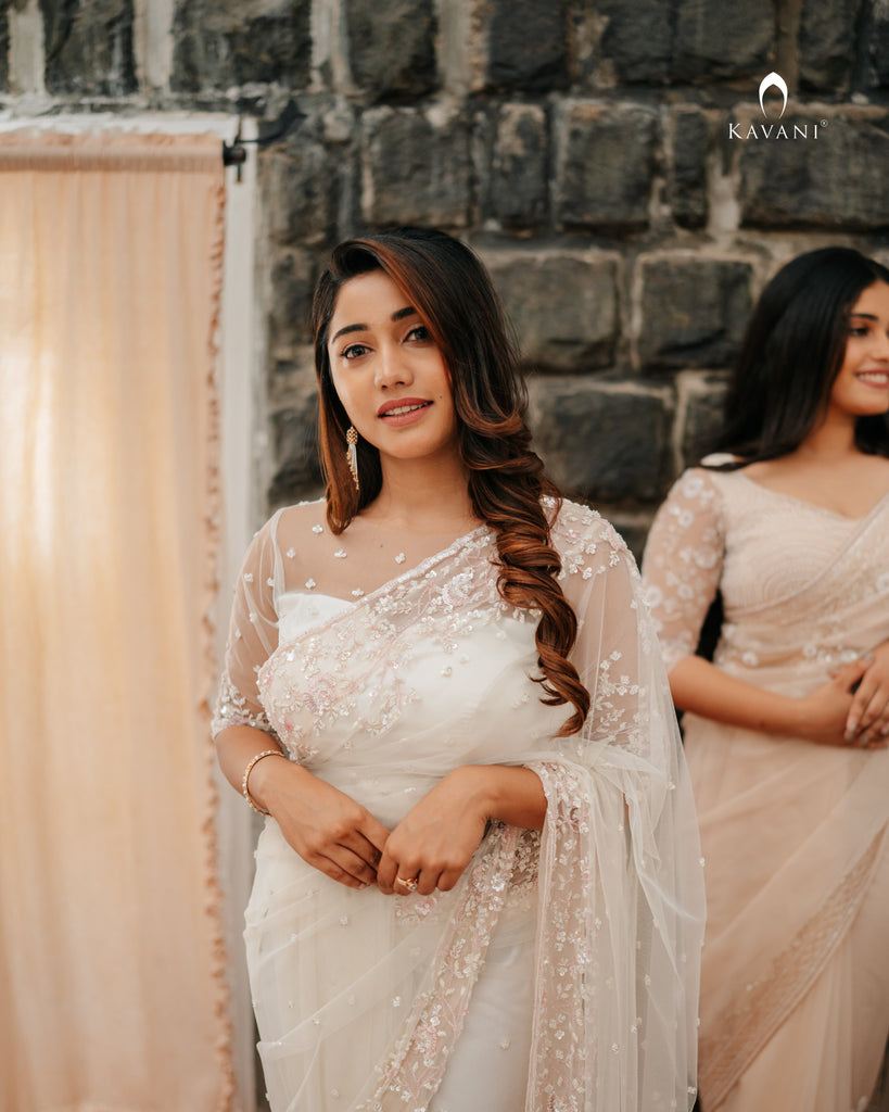 Our signature designer bridal off white saree with hand embroidery with a little pink and rosgold work