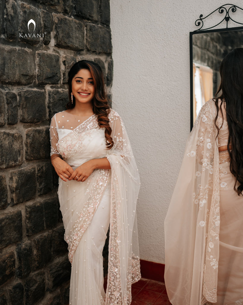 Our signature designer bridal off white saree with hand embroidery with a little pink and rosgold work