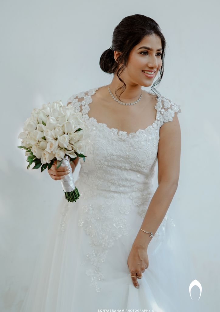 Signature Christian bridal A-line gown in net carried by bride Elizabeth