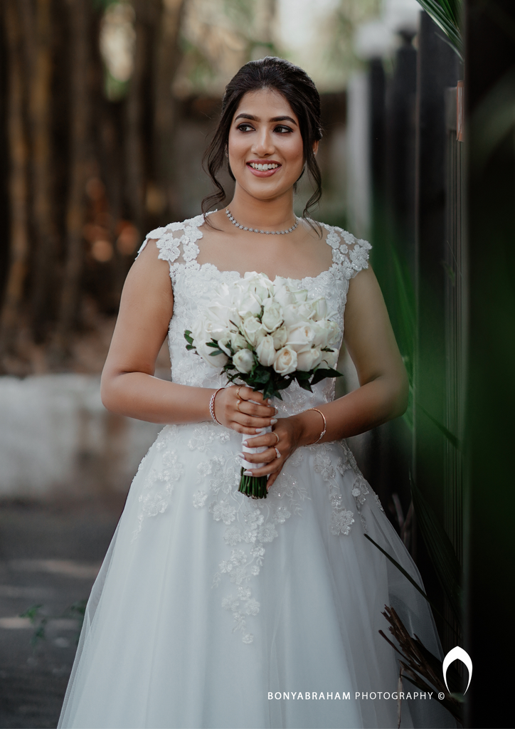Signature Christian bridal A-line gown in net carried by bride Elizabeth