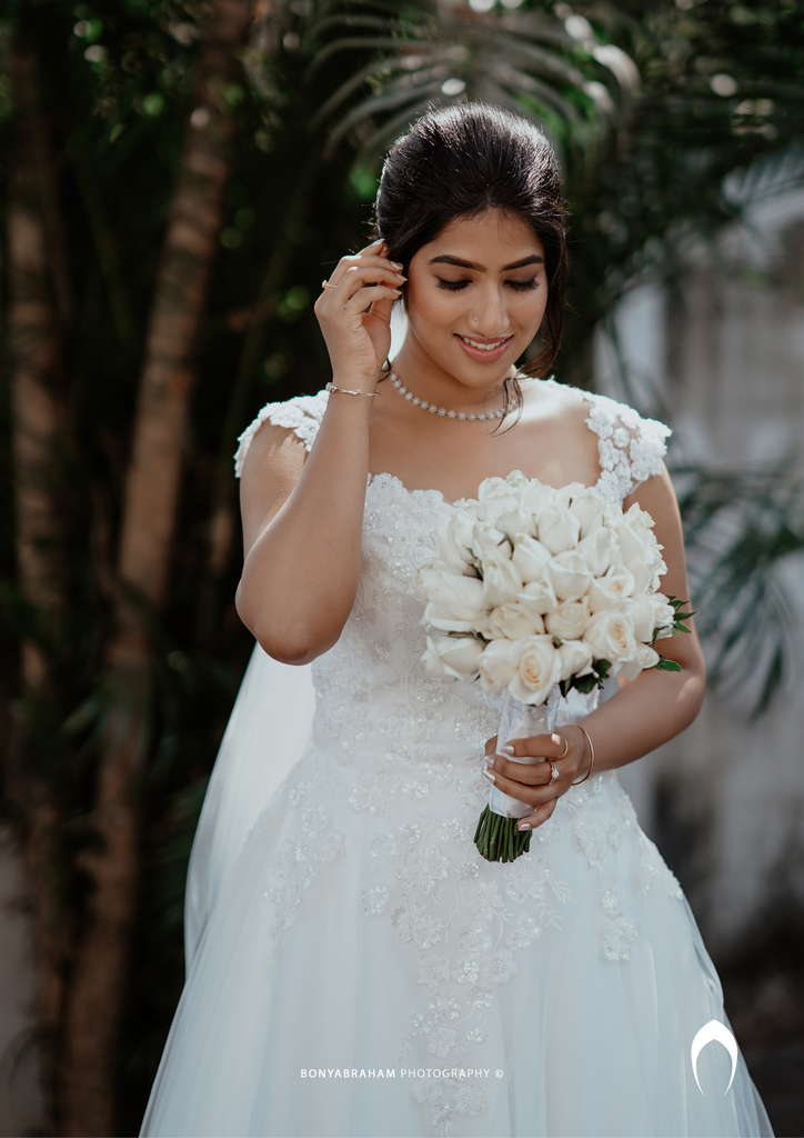 Signature Christian bridal A-line gown in net carried by bride Elizabeth