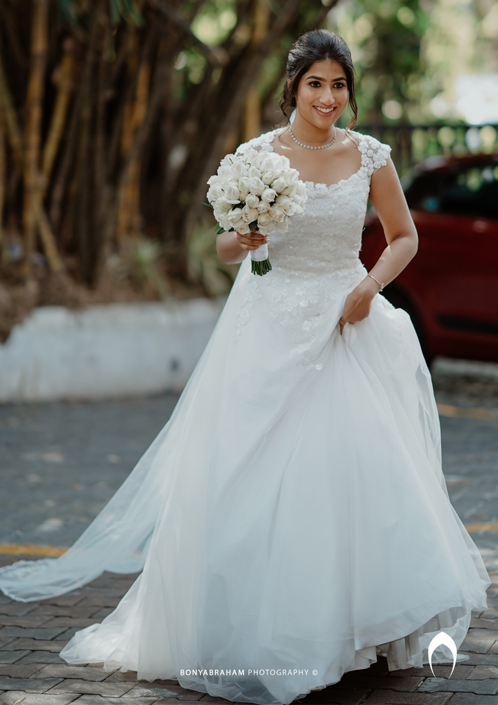 Signature Christian bridal A-line gown in net carried by bride Elizabeth