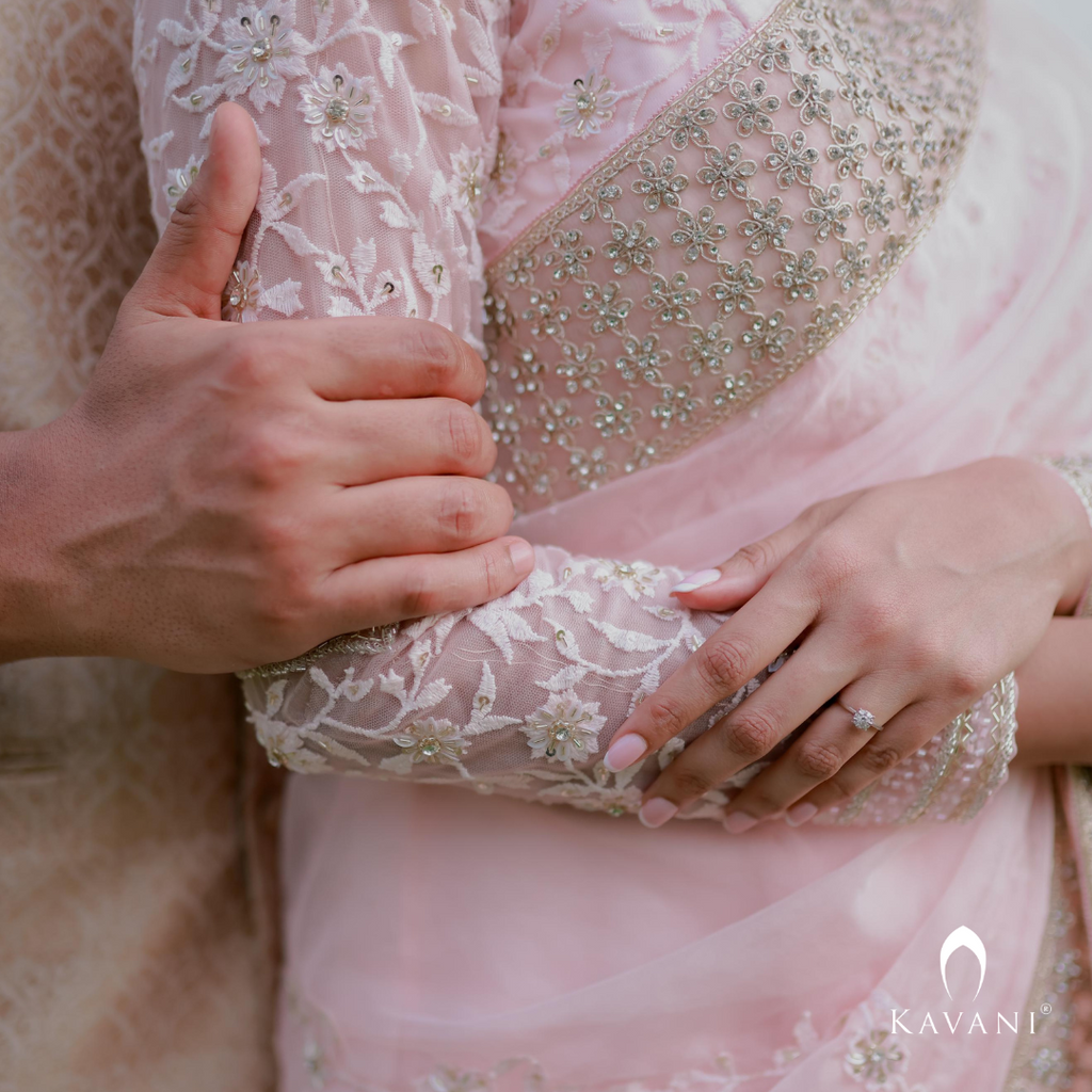 Our bride in her stunning look with a bridal saree in a pinkish shade with enhancing lace embroidery with embellishment done with hand embroidery