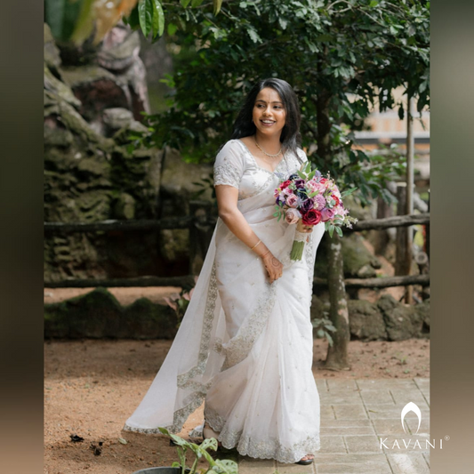 Our bride in her beautiful and stunning looking outlook wearing her bridal organza saree with machine embroidery and hand embroidery