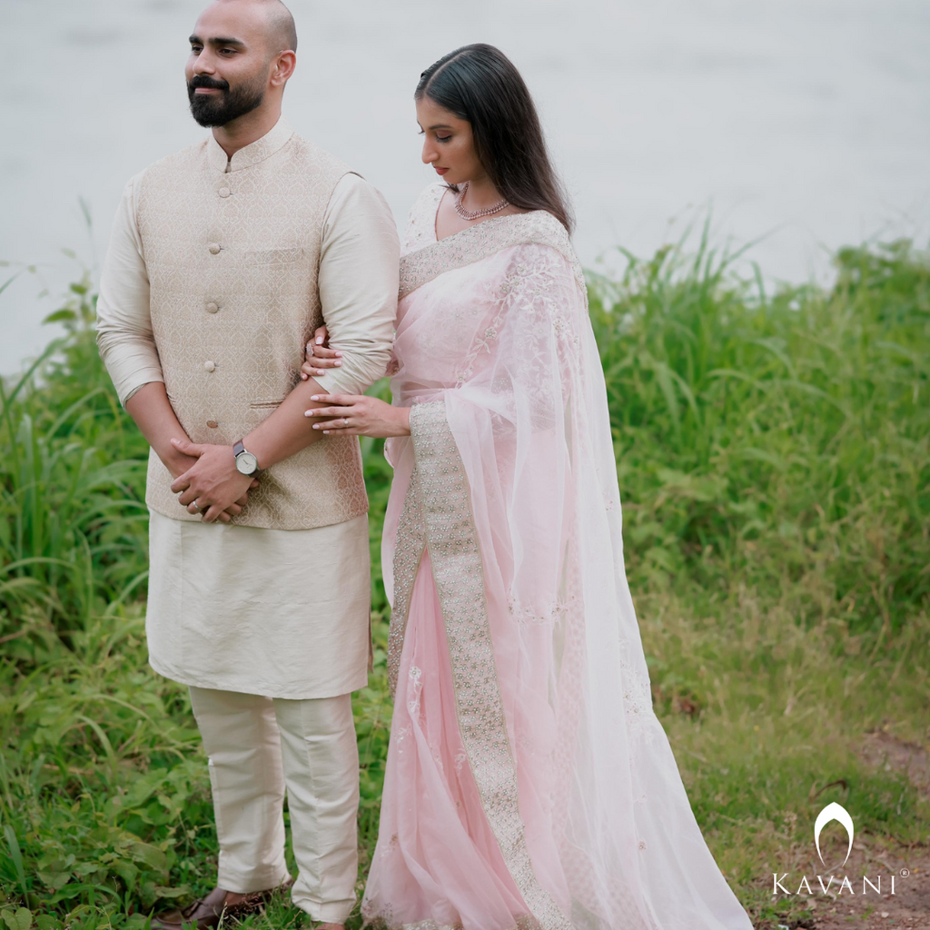 Our bride in her stunning look with a bridal saree in a pinkish shade with enhancing lace embroidery with embellishment done with hand embroidery