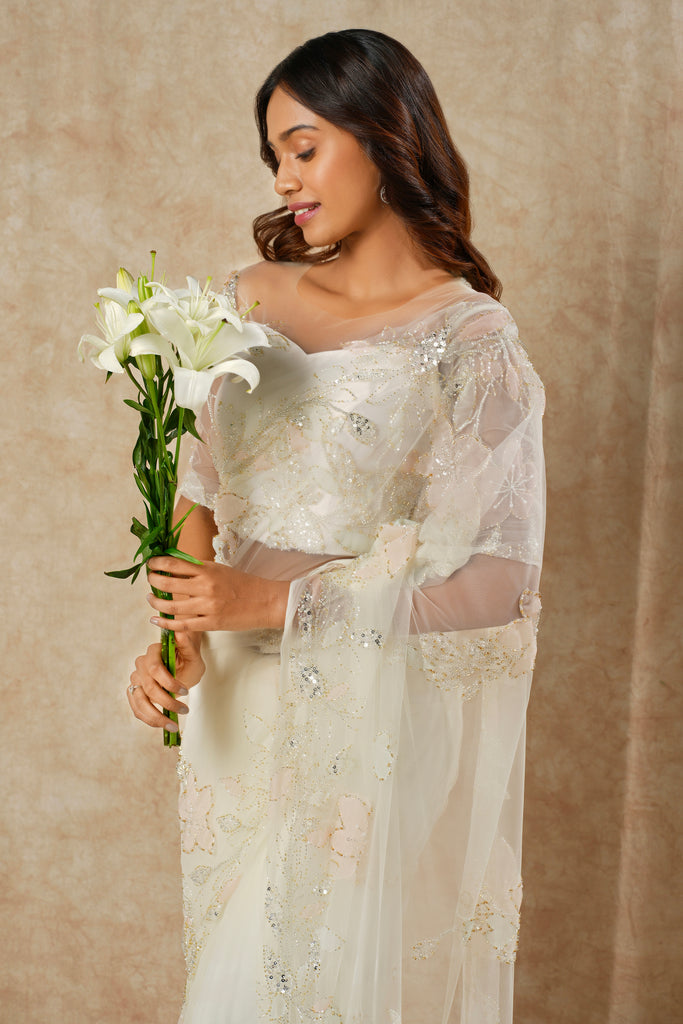 Off-White Saree with Floral Appliqué and Bead Outline Highlighting