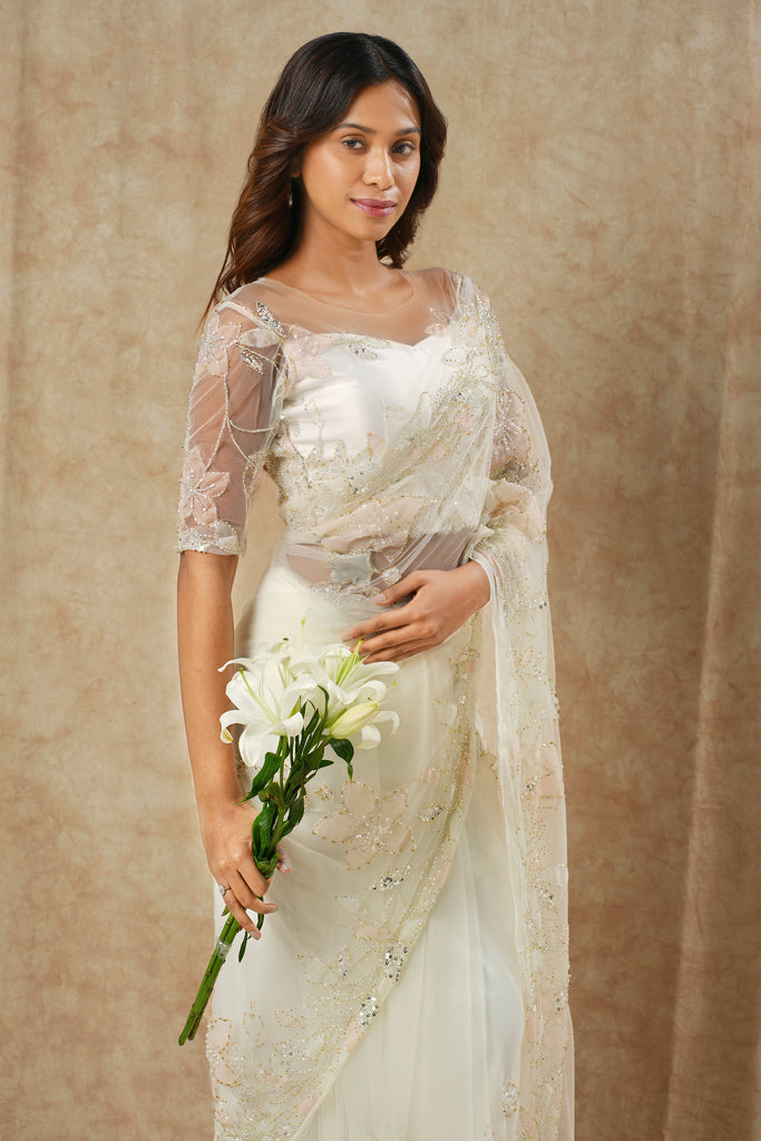 Off-White Saree with Floral Appliqué and Bead Outline Highlighting