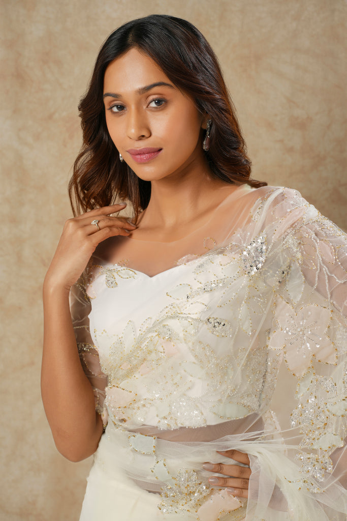Off-White Saree with Floral Appliqué and Bead Outline Highlighting