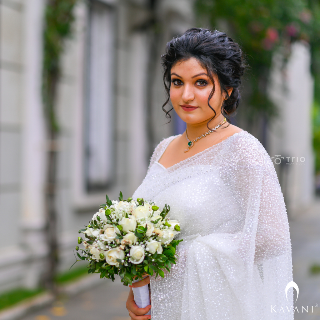 Our bride in her white bridal saree with sequence work with heavy hand embroidey