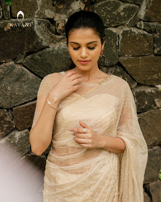 Our signature bridal saree in a light gold shade with beautiful lines of hand embroidery