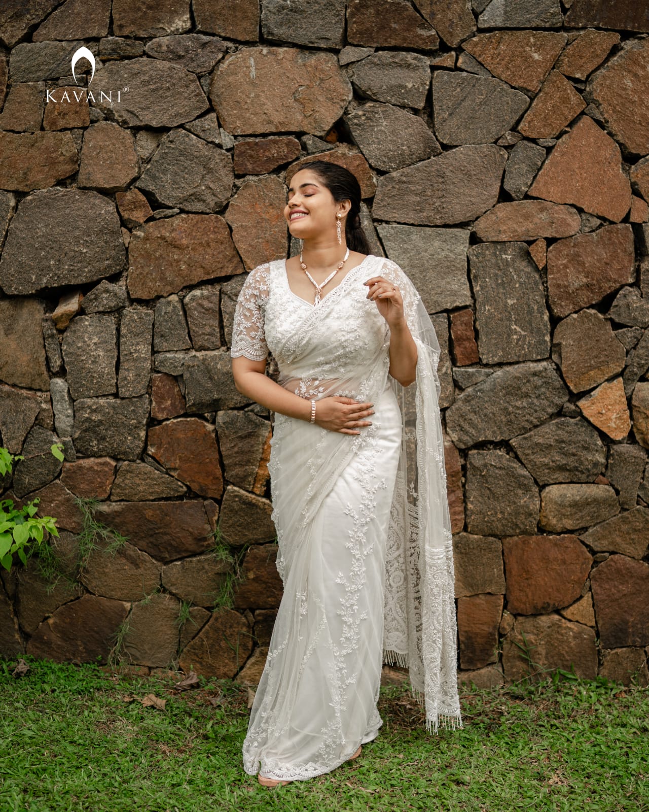 Our signature stunning white bridal saree showing beautiful lace embroidery with embellishments