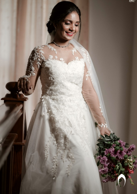 Signature Christian bridal A-line gown in net carried by bride Judith