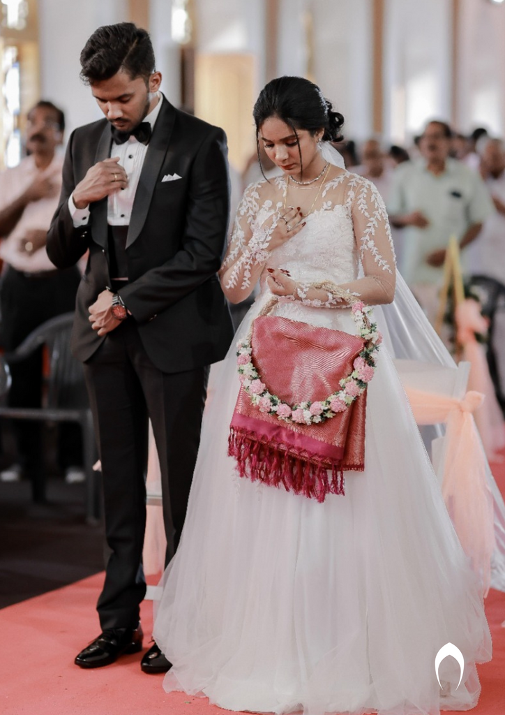 Signature Christian bridal A-line gown in net carried by bride Judith