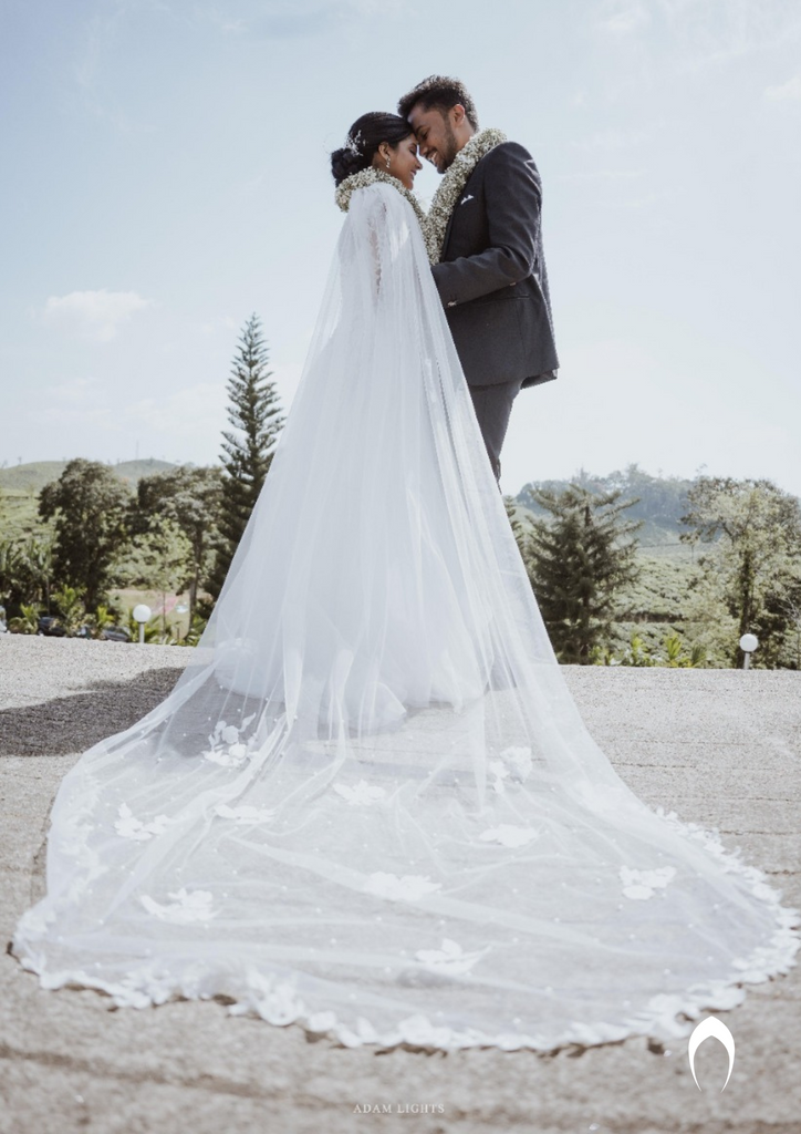 Signature Christian bridal A-line gown in net carried by bride Judith