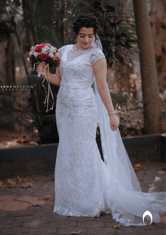 Signature christian bridal trailing champagne gown carried by